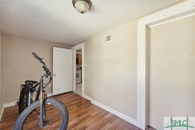 3808 Elmdale Ave, Savannah, GA 31405 - exercise room with wood finished floors, baseboards, and a textured ceiling