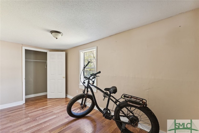 3808 Elmdale Ave, Savannah, GA 31405 - exercise area featuring light wood-type flooring, a textured ceiling, and baseboards