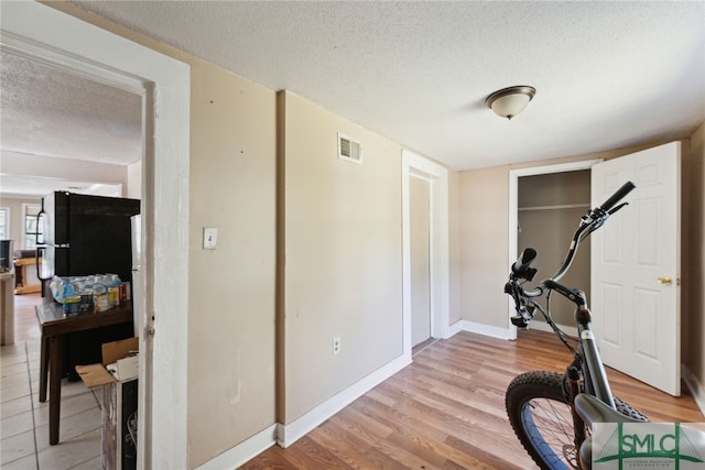 3808 Elmdale Ave, Savannah, GA 31405 - exercise room featuring a textured ceiling, light wood finished floors, and baseboards
