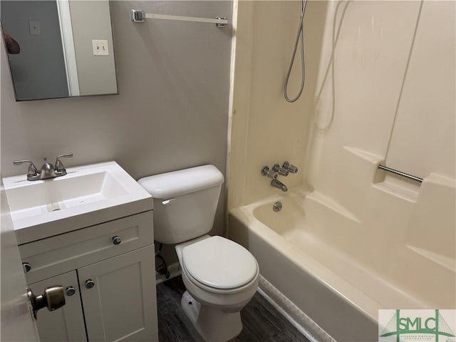 full bath featuring toilet, vanity, wood finished floors, and shower / tub combination