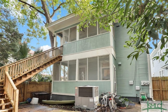 412 E 40th St E, Savannah, GA 31401 - back of property with stairs, a sunroom, central air condition unit, and fence