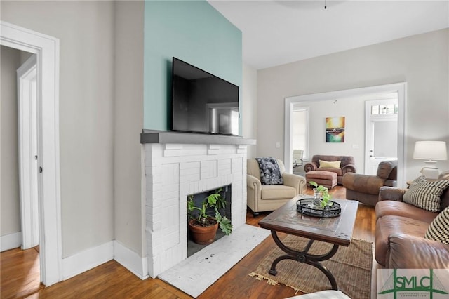 412 E 40th St E, Savannah, GA 31401 - living area featuring wood finished floors, a brick fireplace, and baseboards