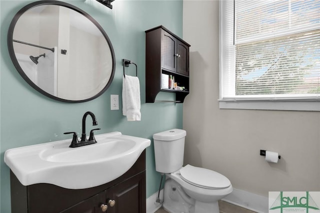 412 E 40th St E, Savannah, GA 31401 - bathroom with toilet, baseboards, and vanity
