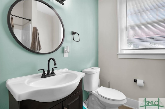 412 E 40th St E, Savannah, GA 31401 - bathroom with toilet, vanity, and baseboards