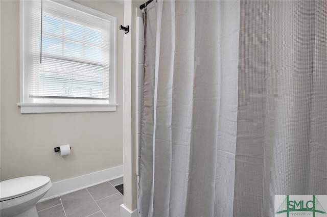 412 E 40th St E, Savannah, GA 31401 - bathroom with tile patterned flooring, healthy amount of natural light, toilet, and baseboards