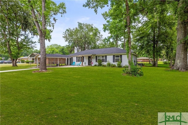81 Quail Ln, Richmond Hill, GA 31324 - ranch-style house with a front yard and a carport