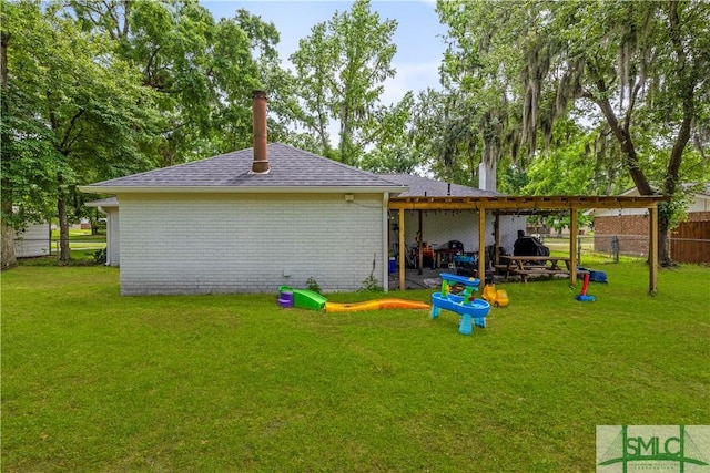 81 Quail Ln, Richmond Hill, GA 31324 - back of property featuring roof with shingles, a chimney, and brick siding