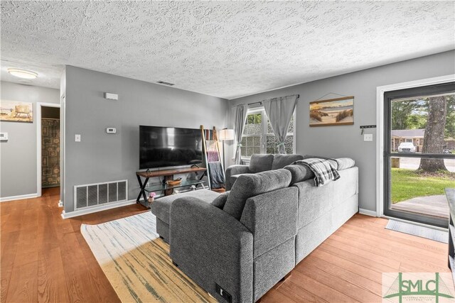 81 Quail Ln, Richmond Hill, GA 31324 - living area featuring wood finished floors, baseboards, and a textured ceiling