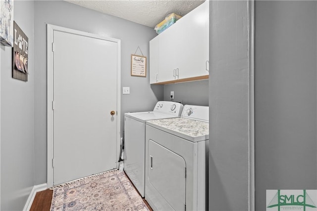 81 Quail Ln, Richmond Hill, GA 31324 - washroom with washer and dryer, cabinet space, a textured ceiling, and light wood-type flooring