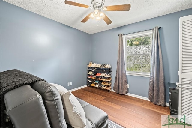 81 Quail Ln, Richmond Hill, GA 31324 - sitting room with baseboards, wood finished floors, a textured ceiling, and ceiling fan