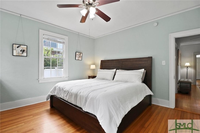 405 E 55th St, Savannah, GA 31405 - bedroom featuring baseboards, wood finished floors, crown molding, and a ceiling fan