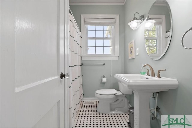 405 E 55th St, Savannah, GA 31405 - bathroom with healthy amount of natural light, toilet, a shower with shower curtain, and crown molding