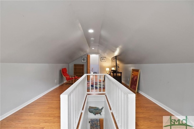 405 E 55th St, Savannah, GA 31405 - hallway with lofted ceiling, wood finished floors, baseboards, recessed lighting, and an upstairs landing