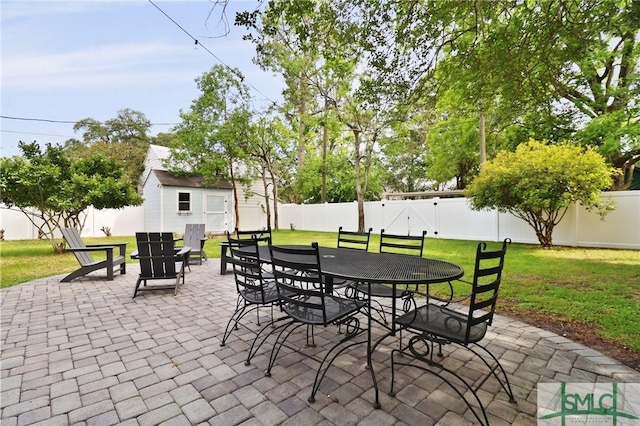 405 E 55th St, Savannah, GA 31405 - view of patio / terrace featuring an outbuilding, outdoor dining area, and a shed
