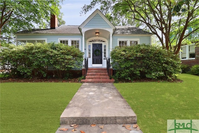 405 E 55th St, Savannah, GA 31405 - view of front facade featuring a chimney and a front yard