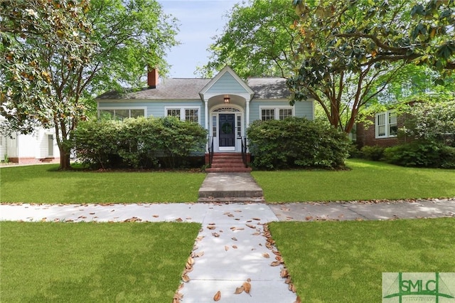 405 E 55th St, Savannah, GA 31405 - view of front facade featuring a front yard and a chimney