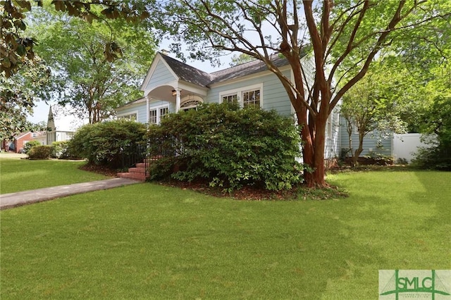 405 E 55th St, Savannah, GA 31405 - view of side of home with a lawn