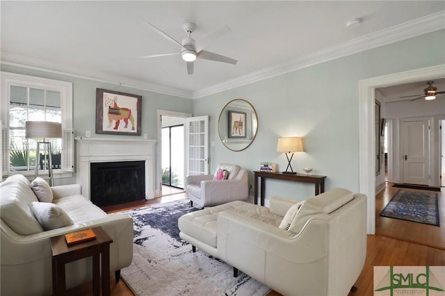 405 E 55th St, Savannah, GA 31405 - living area featuring ceiling fan, wood finished floors, crown molding, and a fireplace