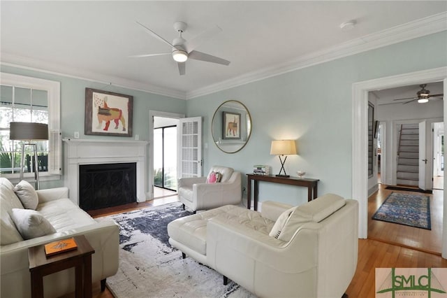 405 E 55th St, Savannah, GA 31405 - living area featuring ceiling fan, wood finished floors, ornamental molding, and a fireplace