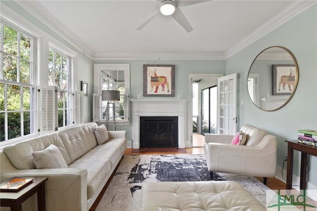405 E 55th St, Savannah, GA 31405 - living room with ceiling fan, wood finished floors, a fireplace with flush hearth, crown molding, and baseboards