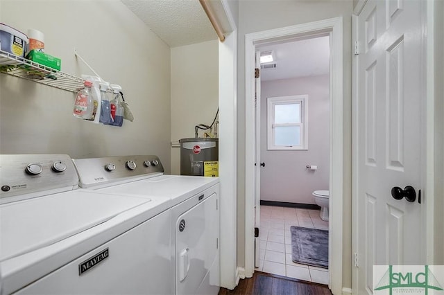 105 Pointe S Dr, Hinesville, GA 31313 - washroom featuring separate washer and dryer, electric water heater, dark wood-style floors, and baseboards