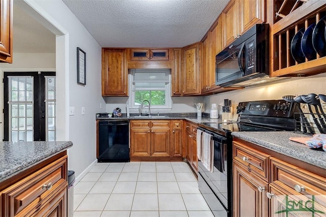 105 Pointe S Dr, Hinesville, GA 31313 - kitchen featuring black appliances, a sink, brown cabinetry, light tile patterned floors, and a textured ceiling