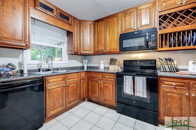 105 Pointe S Dr, Hinesville, GA 31313 - kitchen with black appliances, a sink, brown cabinetry, light tile patterned flooring, and a textured ceiling