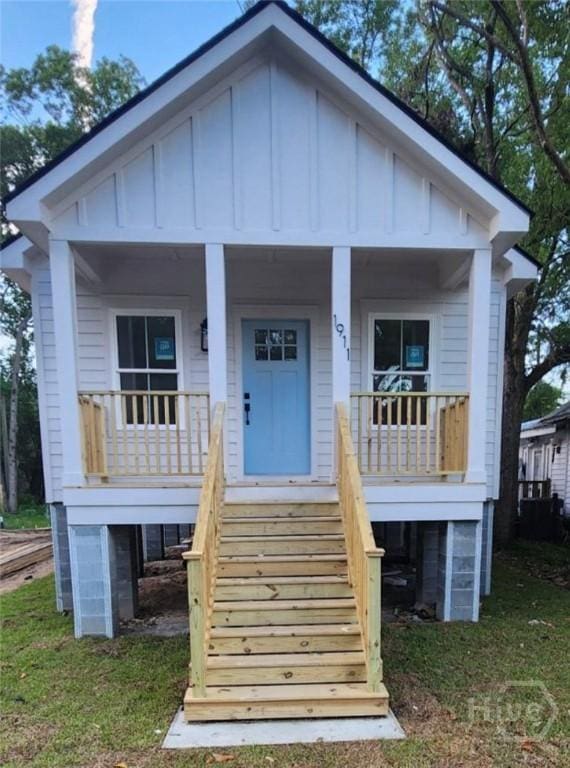 1911 Essex Ave, Savannah, GA 31405 - view of front of property with board and batten siding, covered porch, and stairs