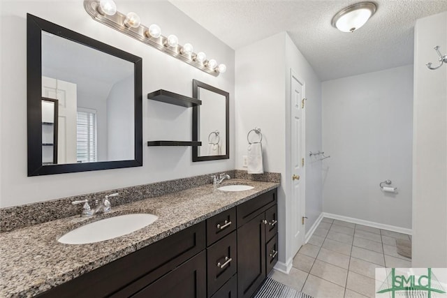 21 Carlisle Ln, Savannah, GA 31419 - full bathroom featuring tile patterned flooring, baseboards, double vanity, and a textured ceiling