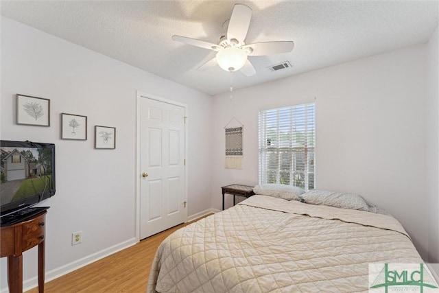 21 Carlisle Ln, Savannah, GA 31419 - bedroom featuring wood finished floors, baseboards, a ceiling fan, and a textured ceiling