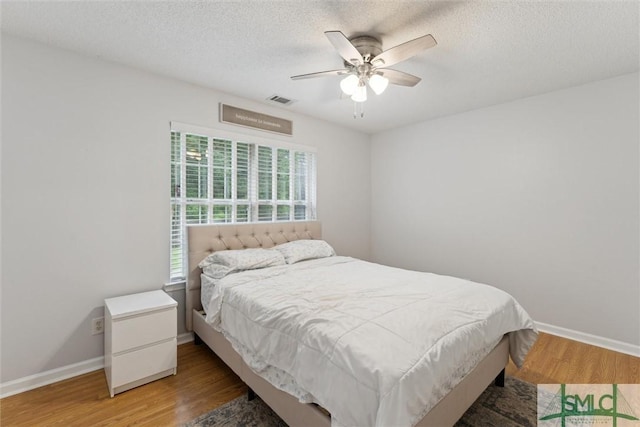 21 Carlisle Ln, Savannah, GA 31419 - bedroom featuring wood finished floors, baseboards, ceiling fan, and a textured ceiling