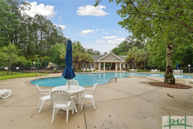 21 Carlisle Ln, Savannah, GA 31419 - community pool featuring fence, a patio, and view of scattered trees