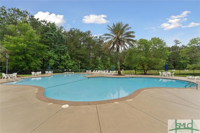 21 Carlisle Ln, Savannah, GA 31419 - community pool featuring fence, a patio, and view of wooded area