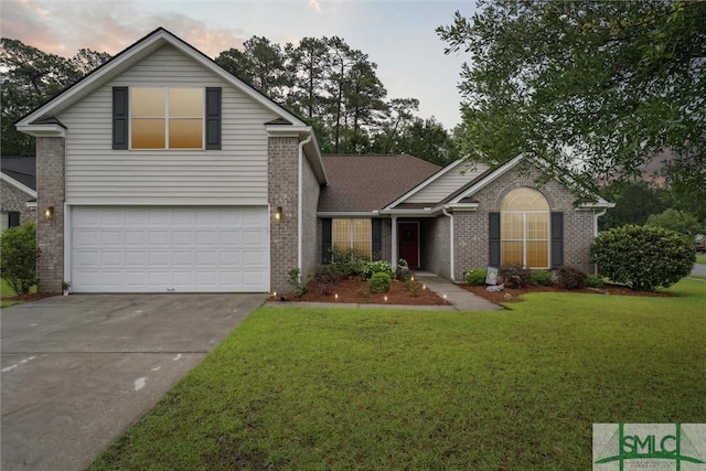 21 Carlisle Ln, Savannah, GA 31419 - traditional home with brick siding, concrete driveway, a yard, and an attached garage