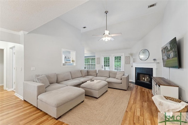 21 Carlisle Ln, Savannah, GA 31419 - living area with light wood-style floors, a ceiling fan, a tiled fireplace, lofted ceiling, and baseboards
