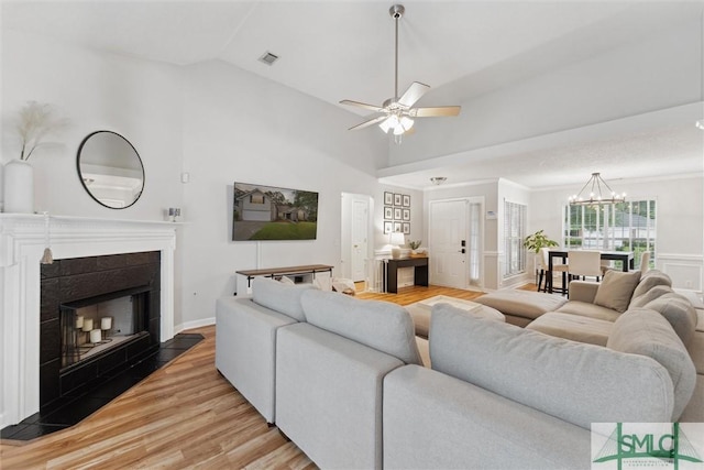 21 Carlisle Ln, Savannah, GA 31419 - living room featuring light wood-style floors, a ceiling fan, lofted ceiling, a chandelier, and a fireplace with flush hearth