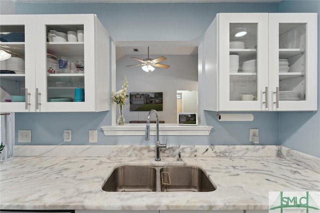 21 Carlisle Ln, Savannah, GA 31419 - kitchen featuring a sink, light stone countertops, white cabinetry, glass insert cabinets, and vaulted ceiling