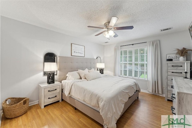 21 Carlisle Ln, Savannah, GA 31419 - bedroom with a textured ceiling, light wood-style floors, baseboards, and ceiling fan