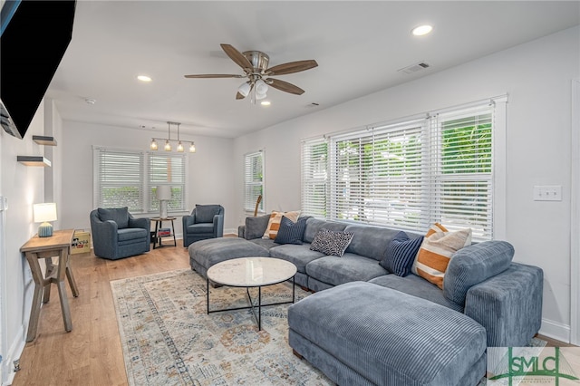 living area with plenty of natural light, light wood-type flooring, a ceiling fan, recessed lighting, and baseboards
