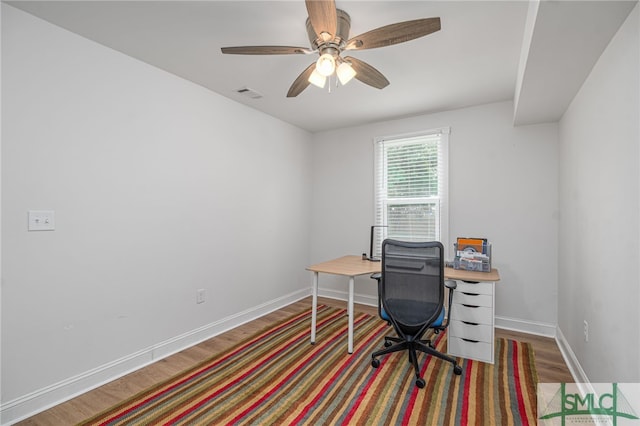 office area with wood finished floors, baseboards, and a ceiling fan