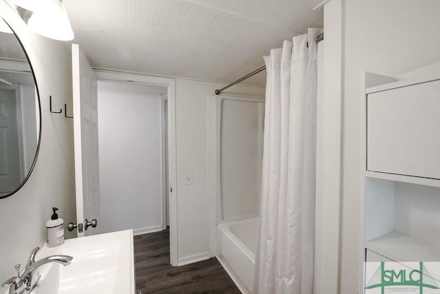 bathroom with wood finished floors and shower / bath combo with shower curtain