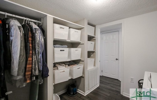 bathroom featuring wood finished floors, baseboards, and a textured ceiling