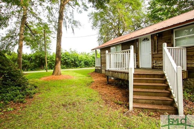 view of grassy yard with a deck