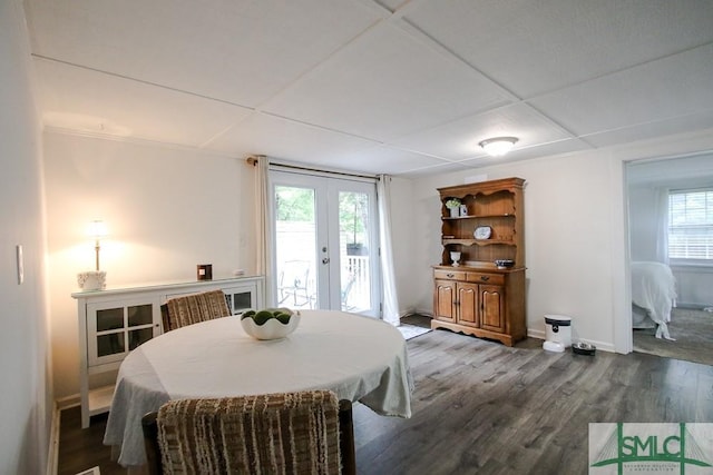 dining space with french doors, dark wood finished floors, and baseboards