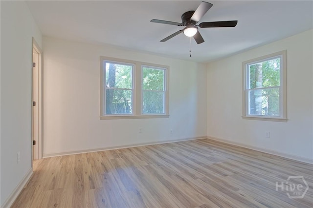 unfurnished room with light wood-type flooring, ceiling fan, and baseboards