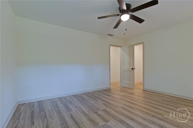 empty room featuring light wood-type flooring, baseboards, and ceiling fan