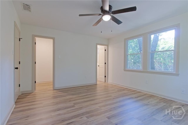 unfurnished bedroom with light wood-style flooring, baseboards, and a ceiling fan