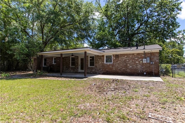 back of house featuring brick siding, a patio area, an attached carport, and ceiling fan