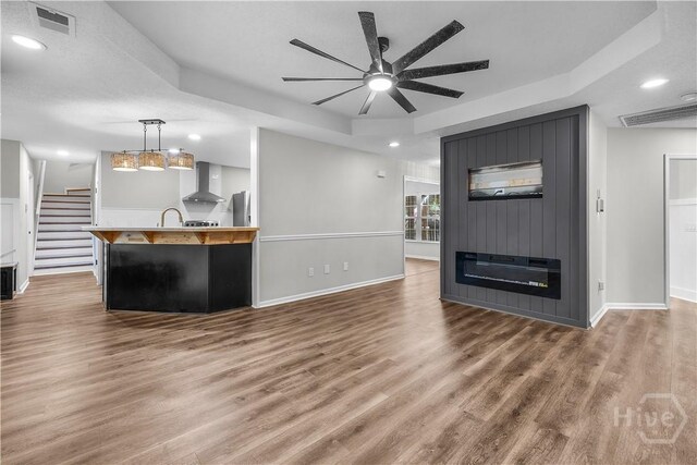 407 Middleton St, Pooler, GA 31322 - unfurnished living room with a raised ceiling, a ceiling fan, recessed lighting, wood finished floors, and baseboards