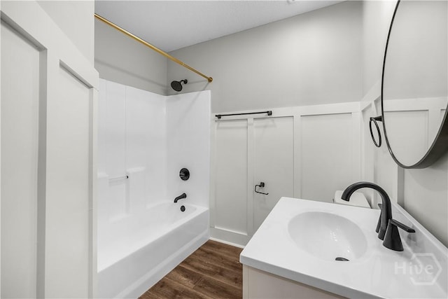 407 Middleton St, Pooler, GA 31322 - full bathroom featuring wood finished floors, shower / bathtub combination, vanity, wainscoting, and a decorative wall